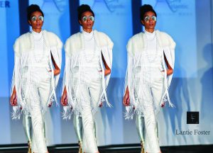Extra long white fringe on the runway, white fur, white top, silver pants,silver necklace.